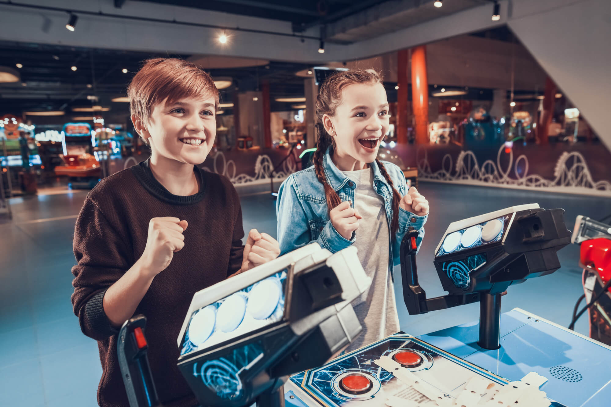 Boy and girl playing arcade game