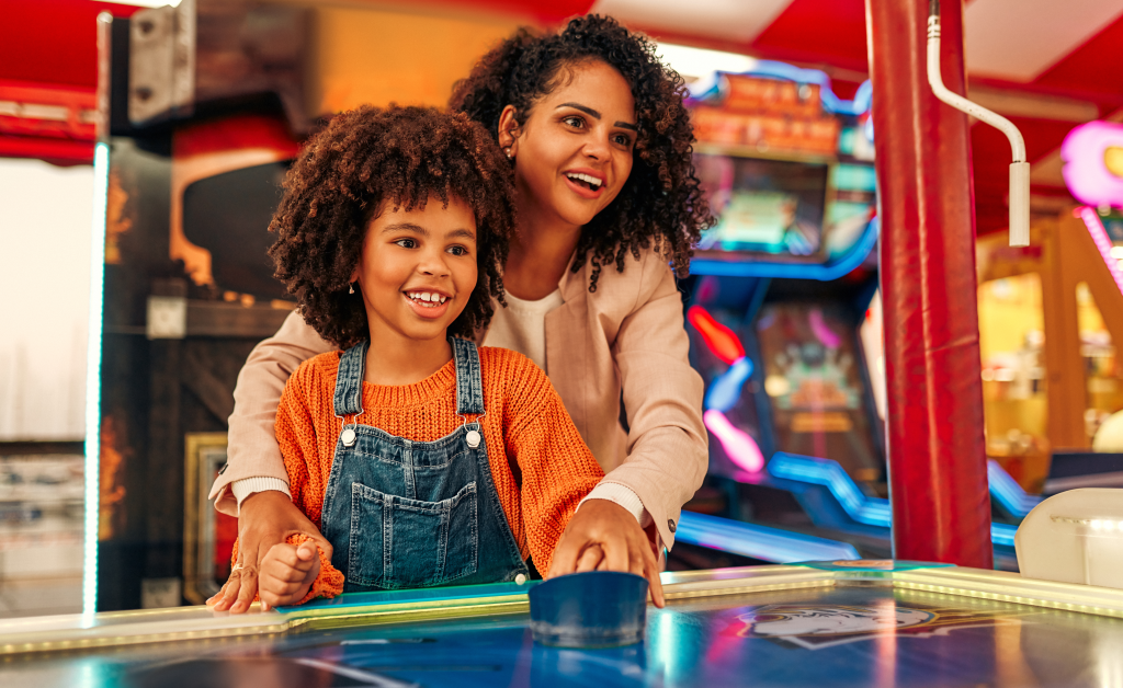 Mom and daughter playing classic arcade games